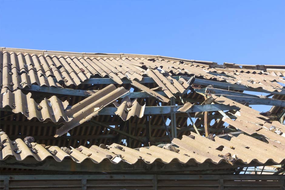Roof that has been severely damaged by a wind storm.
