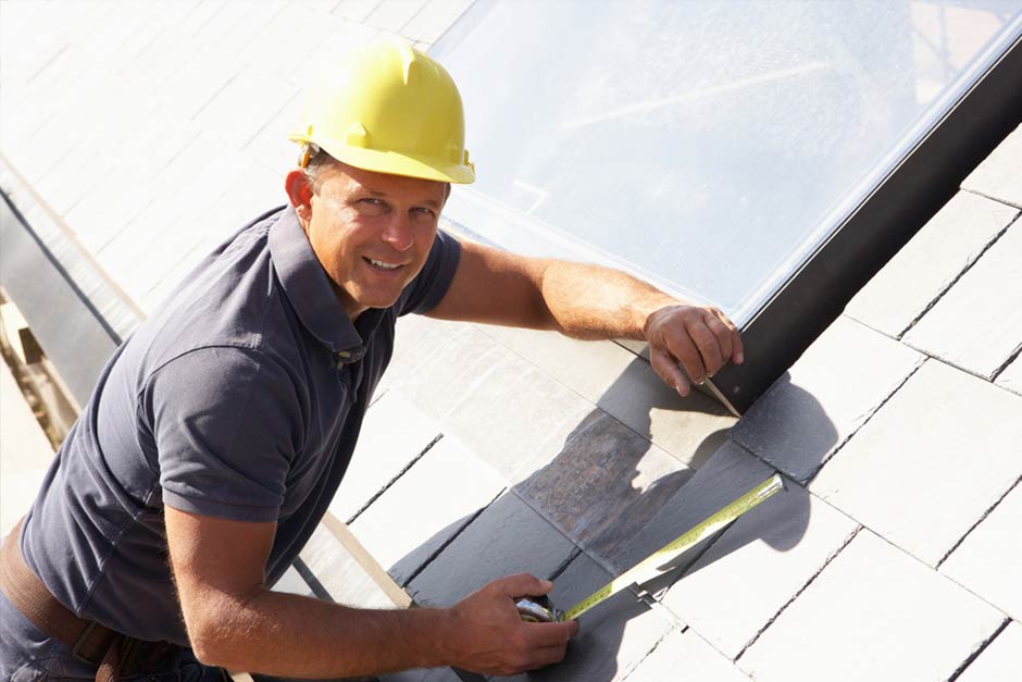 man coating a roof