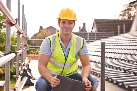 Roofing contractor documenting hail damage for insurance claim