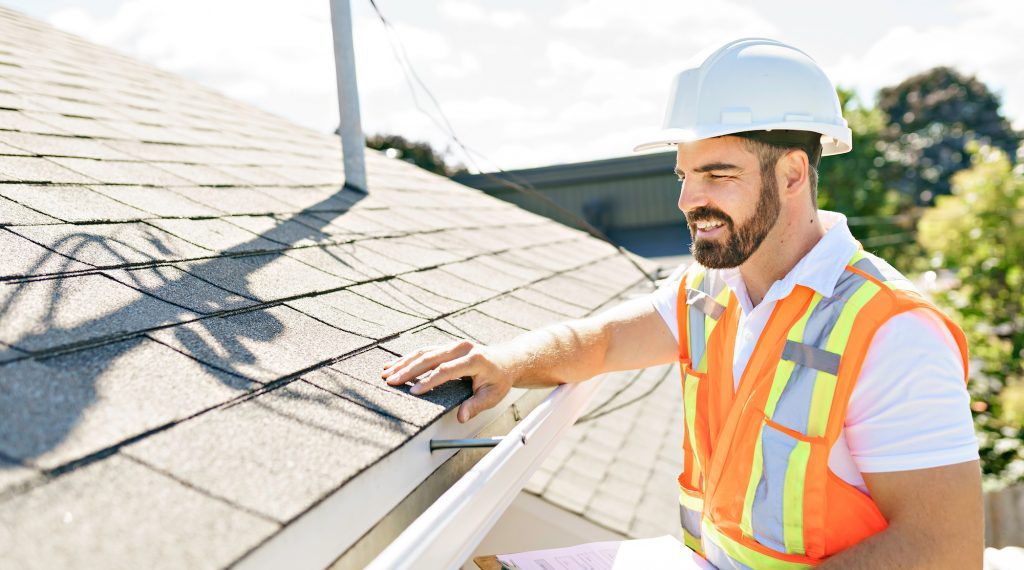 A young El Paso roofing contractor performing a roof inspection for a newly-built home.