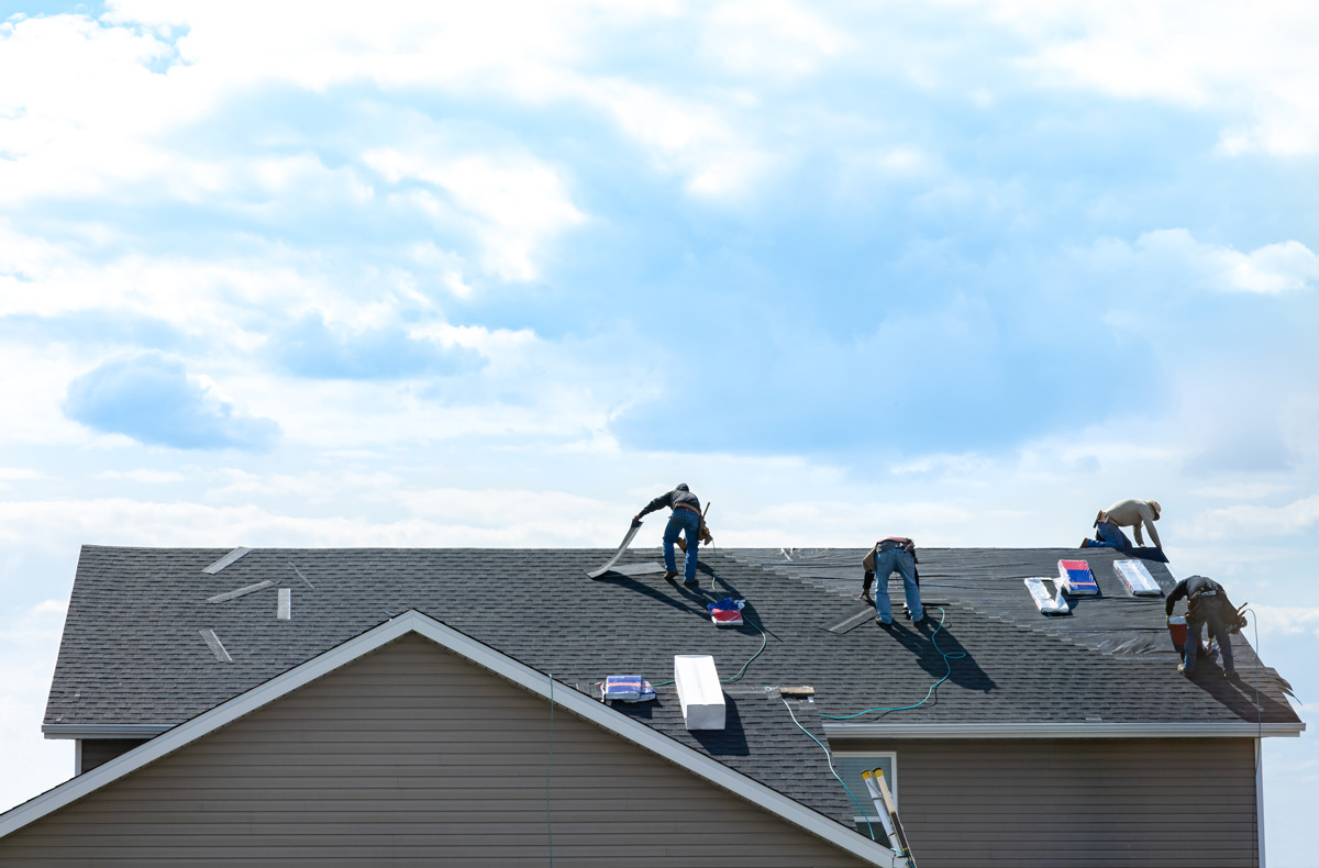 Four men on a roof in El Paso.